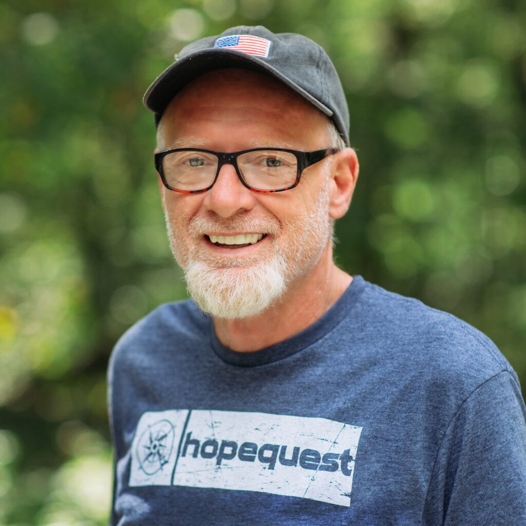 Paul Bennett wearing a HopeQuest t-shirt and hat with an American flag.