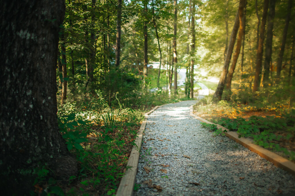 Pebbled path through nature on HopeQuest campus
