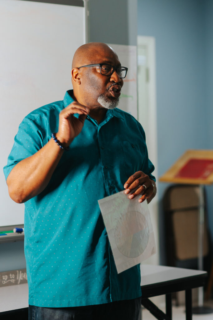 HopeQuest mentor shares The Feeling Wheel graphic with a group