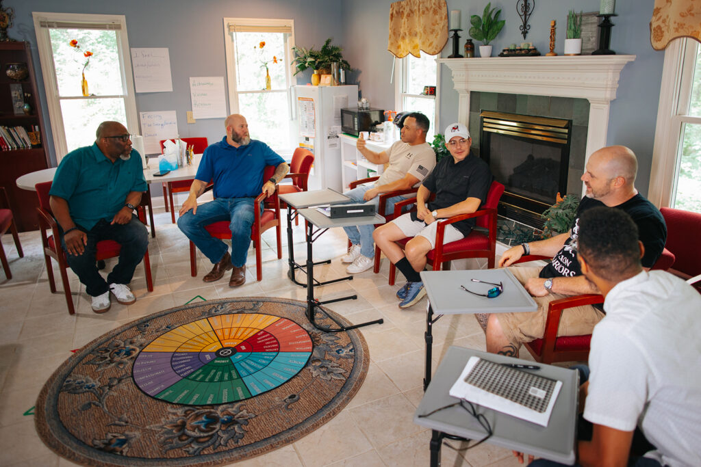 HopeQuest Campus Photo of men sitting in a group sharing their journeys