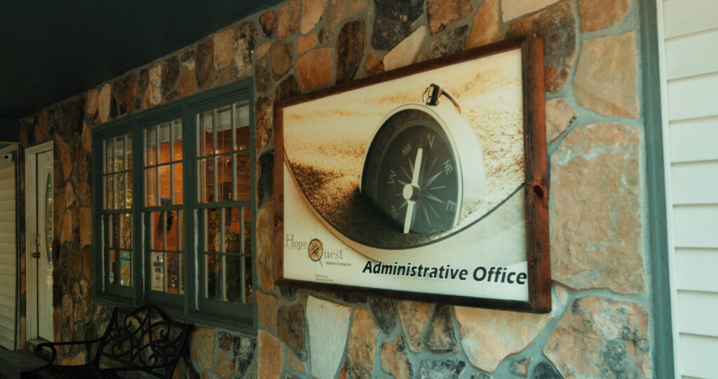 HopeQuest compass in the sand Administrative Office sign