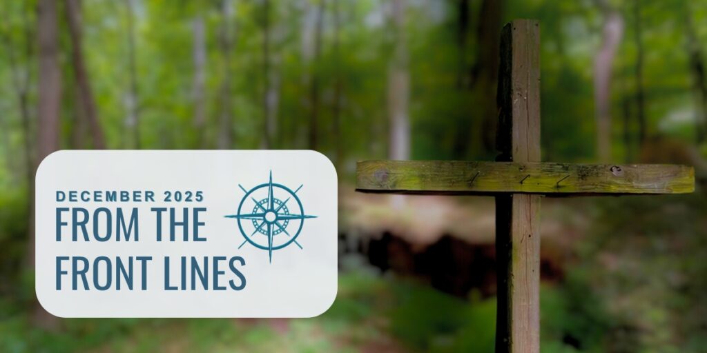 December 2025 newsletter image: Wooden cross in a forest.